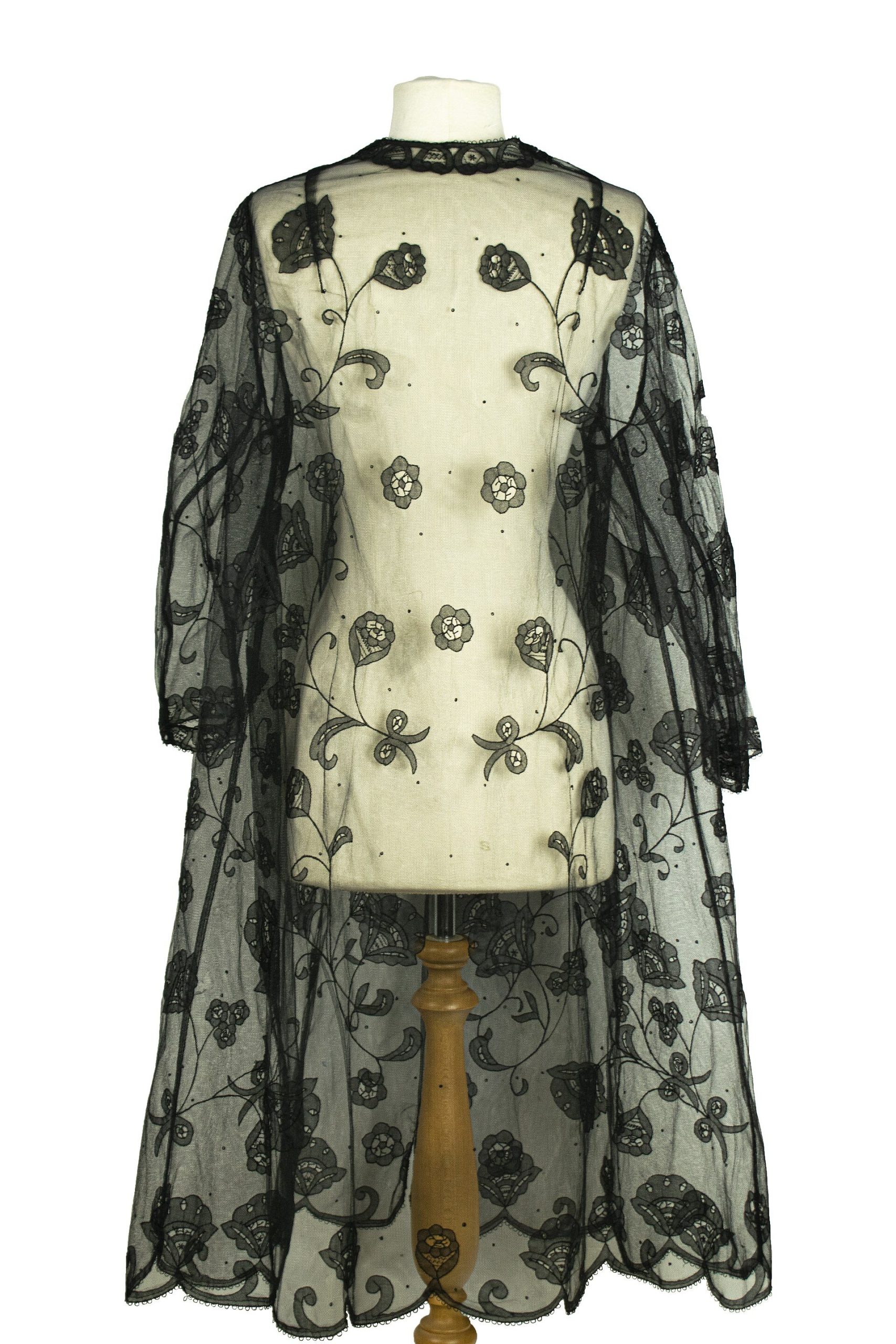 The black lace kimono worn open, with long wide sleeves